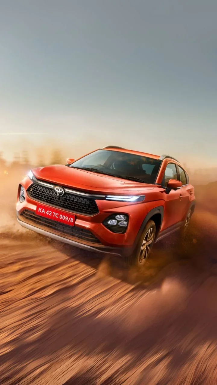 2025 toyota taisor orange front driving shot