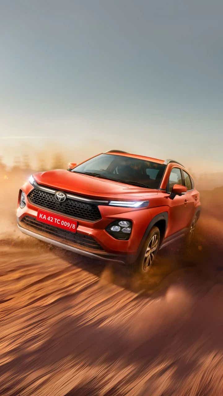 2025 toyota taisor orange front driving shot