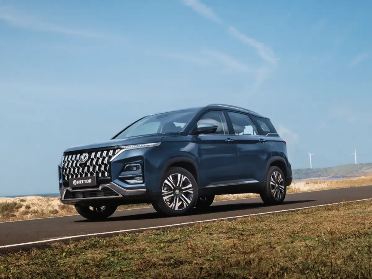 MG Hector Caledon Blue driving on a road.