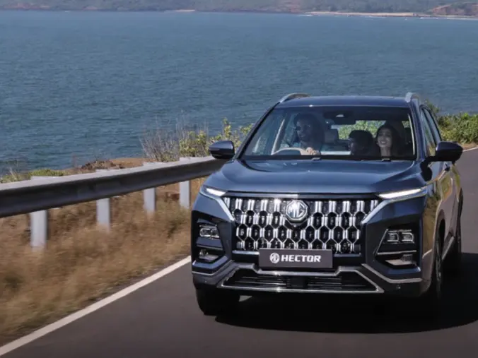 MG Hector FaceliftMG Hector Caledon Blue shade driving on a coastal road.