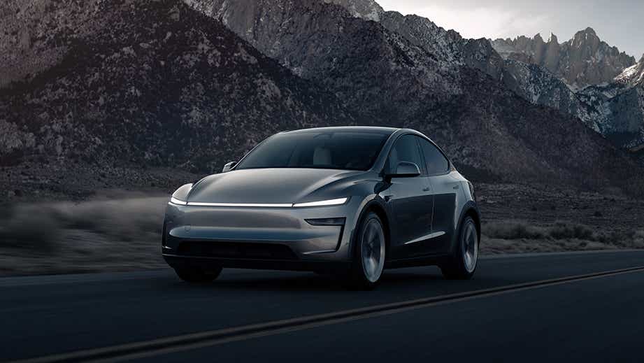 front three-quarter view of a Tesla Model Y on a mountain road