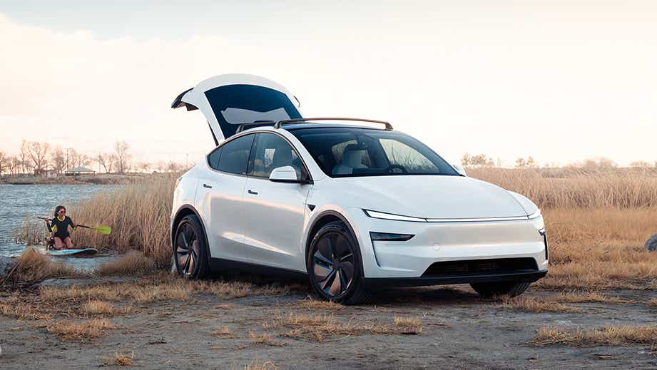 front three-quarter view of a Pearl White Multi-Coat Tesla Model Y with open rear hatch
