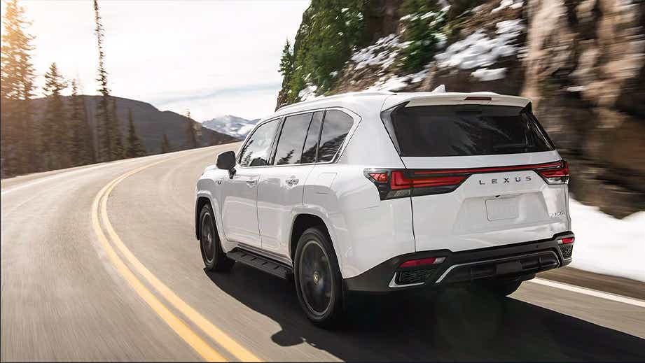 rear three-quarter view of a Lexus LX on a mountain road