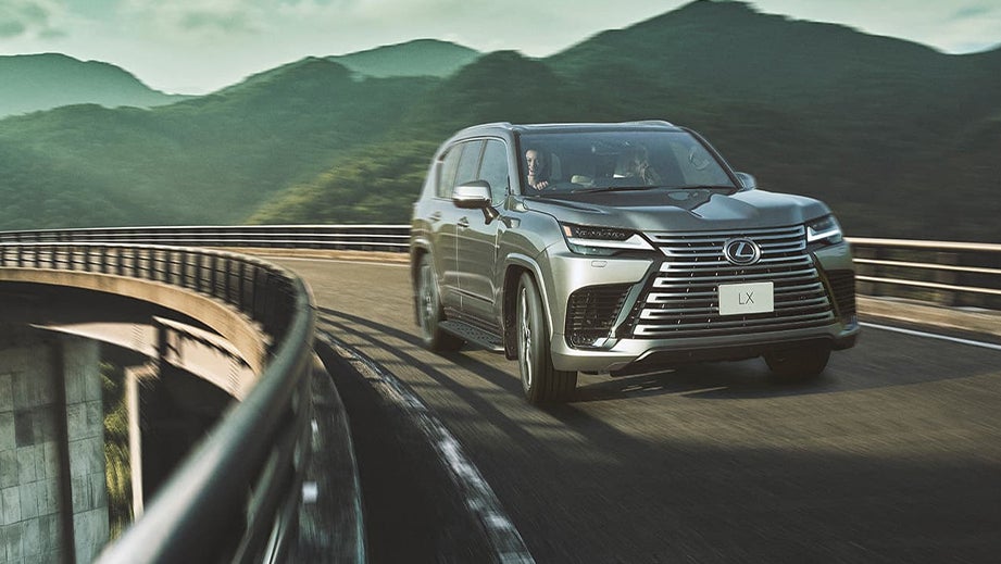 front three-quarter view of a Lexus LX on a winding mountain road