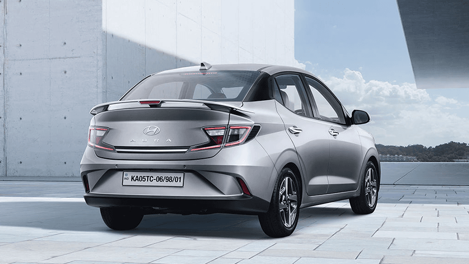 rear three-quarter of a Typhoon Silver Hyundai Aura