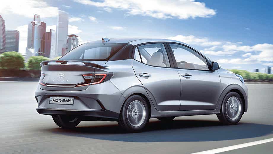 rear three-quarter of a Typhoon Silver Hyundai Aura