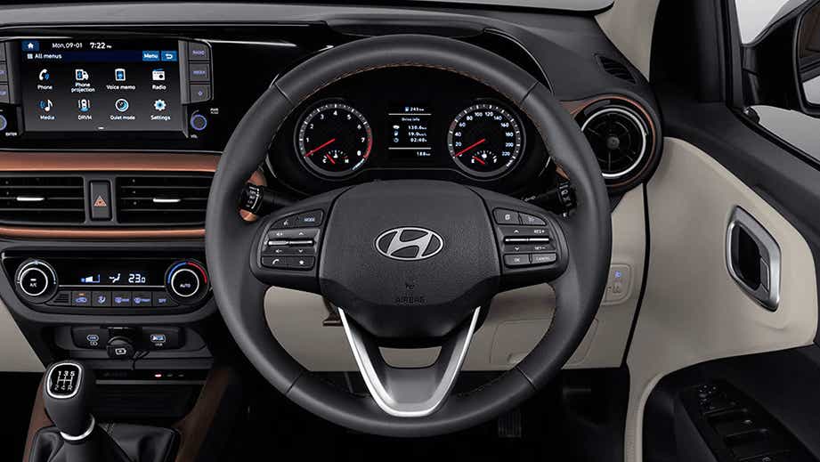 Dashboard and steering wheel view of a Hyundai Aura interior