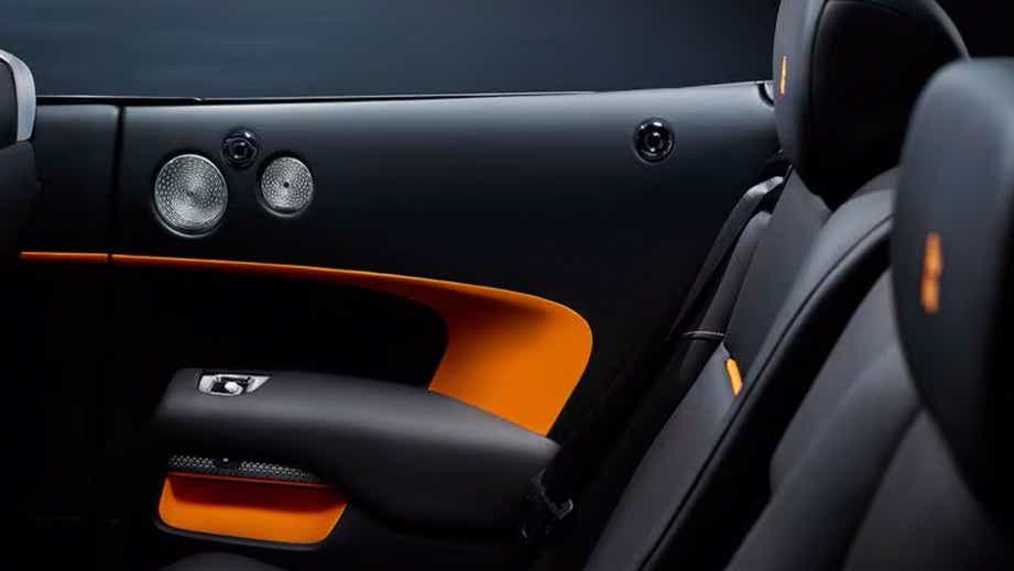 interior rear seats and side panel of a Sunny Yellow Rolls-Royce Dawn