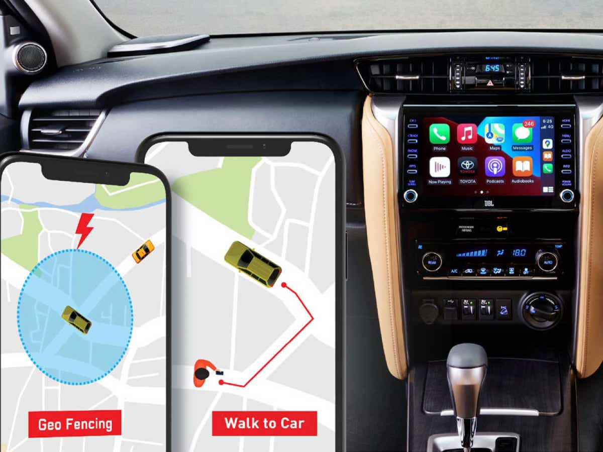 interior dashboard of a Toyota Fortuner facelift with infotainment system and smartphones showing geo-fencing features