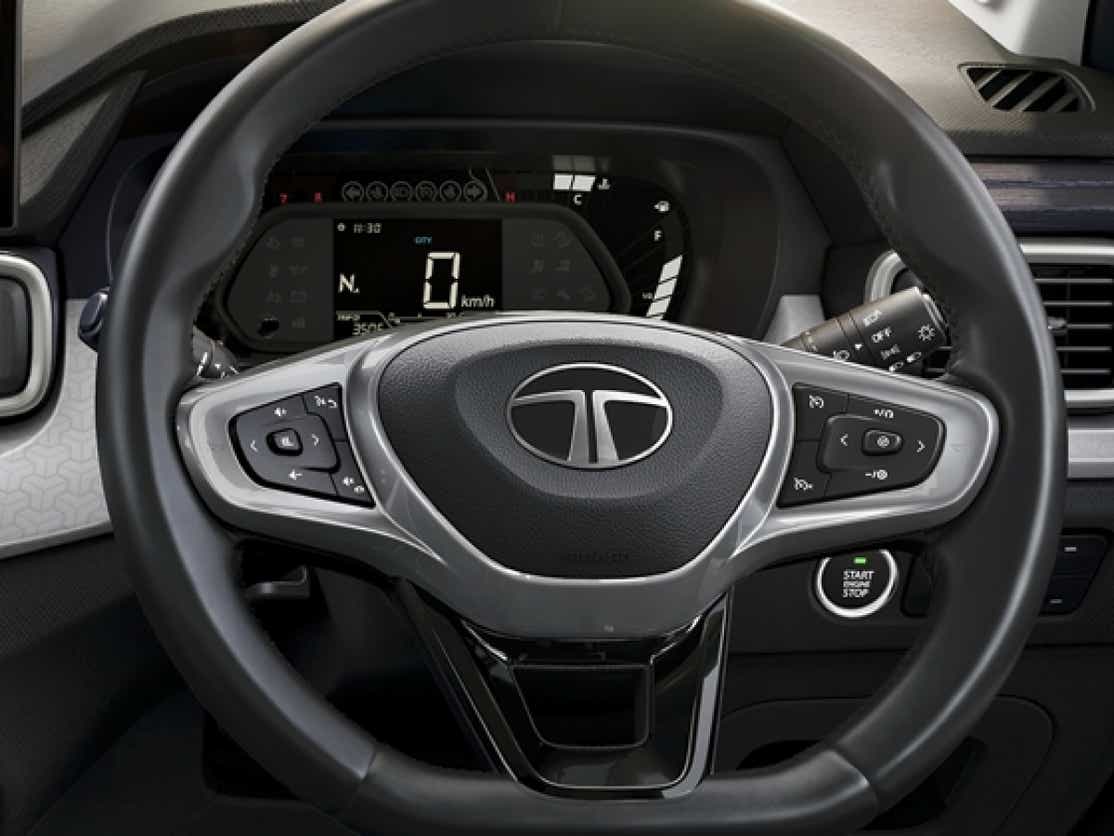Interior dashboard and steering wheel of a Black Tata Punch Facelift