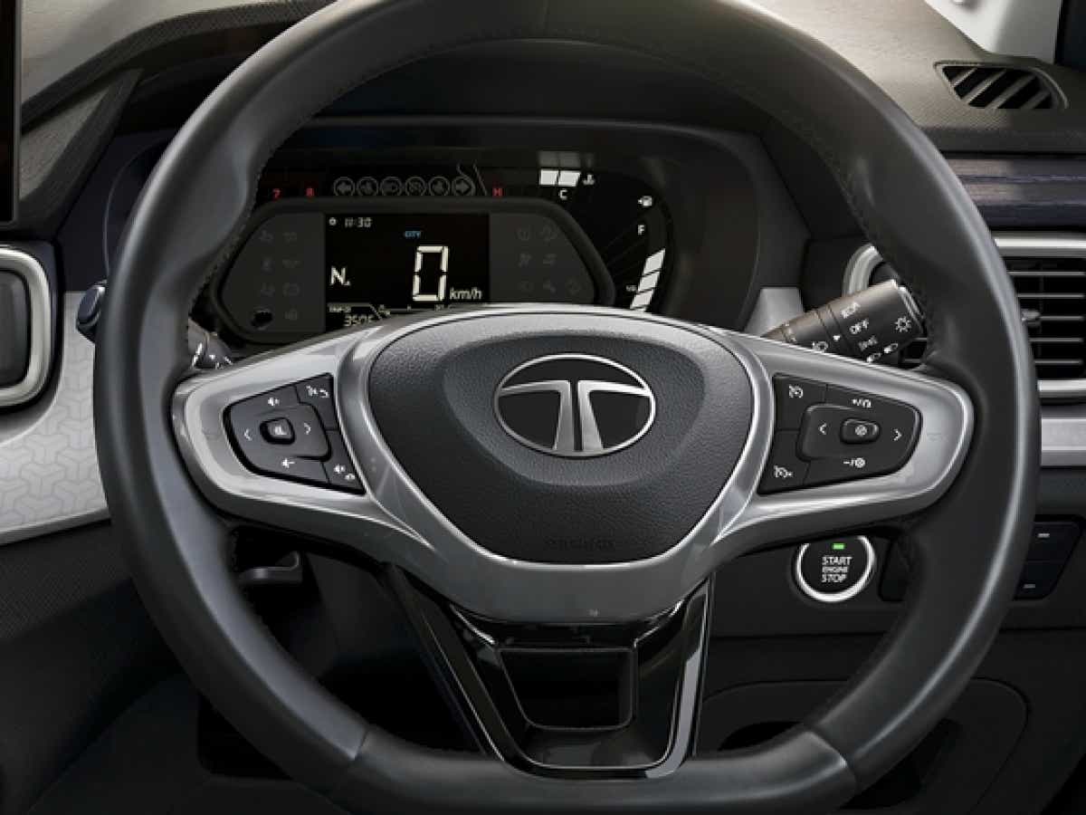 Interior dashboard and steering wheel of a Black Tata Punch Facelift
