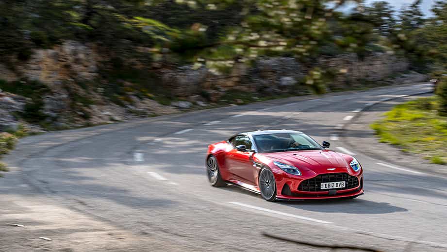 front three-quarter of an Aston Martin DB12 on a winding road