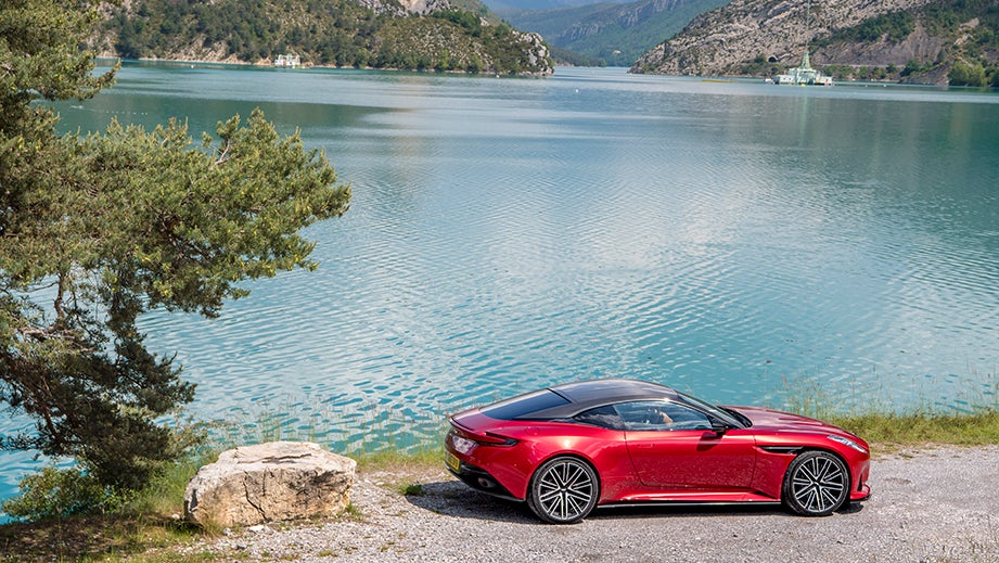 side view of a Aston Martin DB12 coupe by a lake