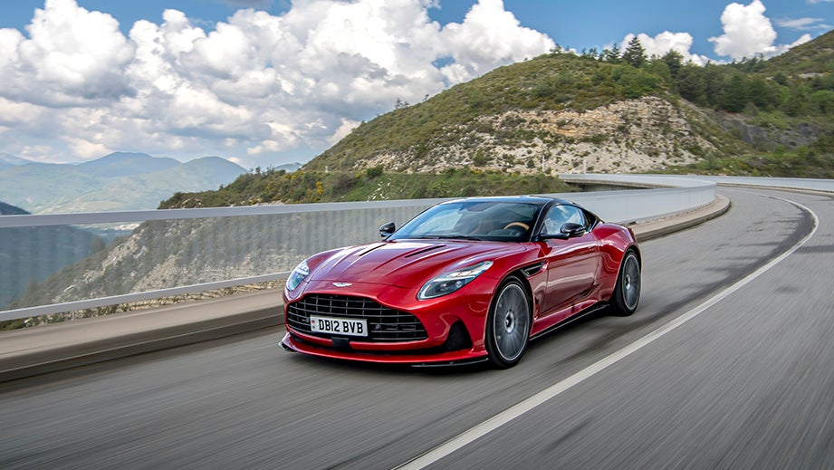 front three-quarter view of an Hyper Red Aston Martin DB12