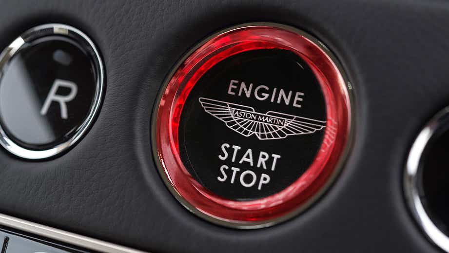 Close-up of the engine start/stop button in an Aston Martin DB11