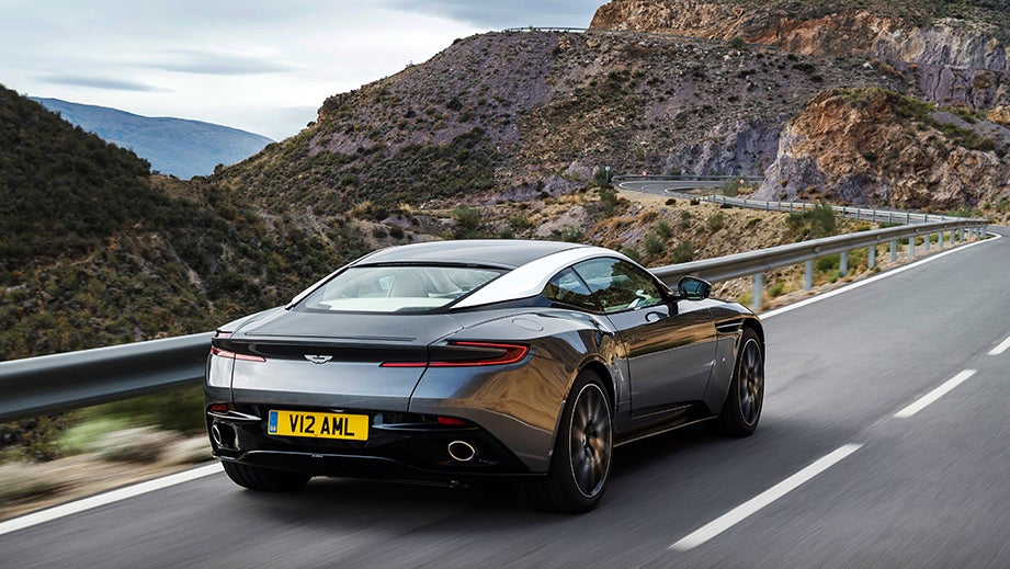Rear three-quarter view of a Tiffany Green Aston Martin DB11