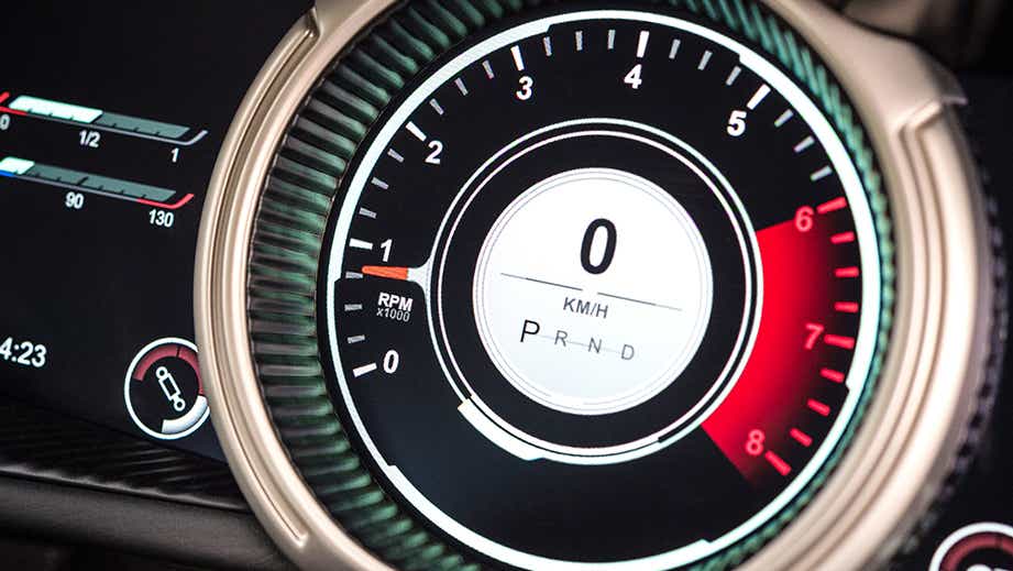 Instrument cluster close-up of a Tiffany Green Aston Martin DB11