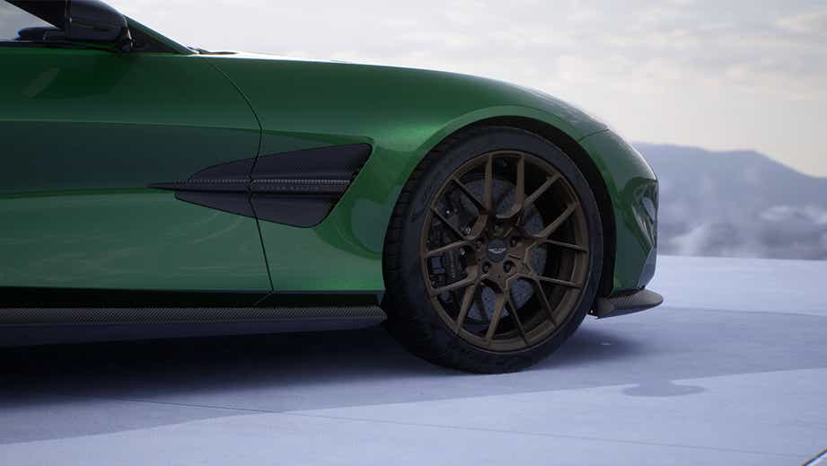 Front wheel and side view of a Podium Green Aston Martin Vanquish