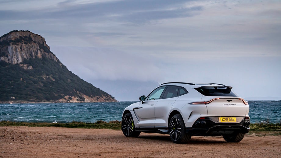 Rear three-quarter view of a Satin Lunar White Aston Martin DBX