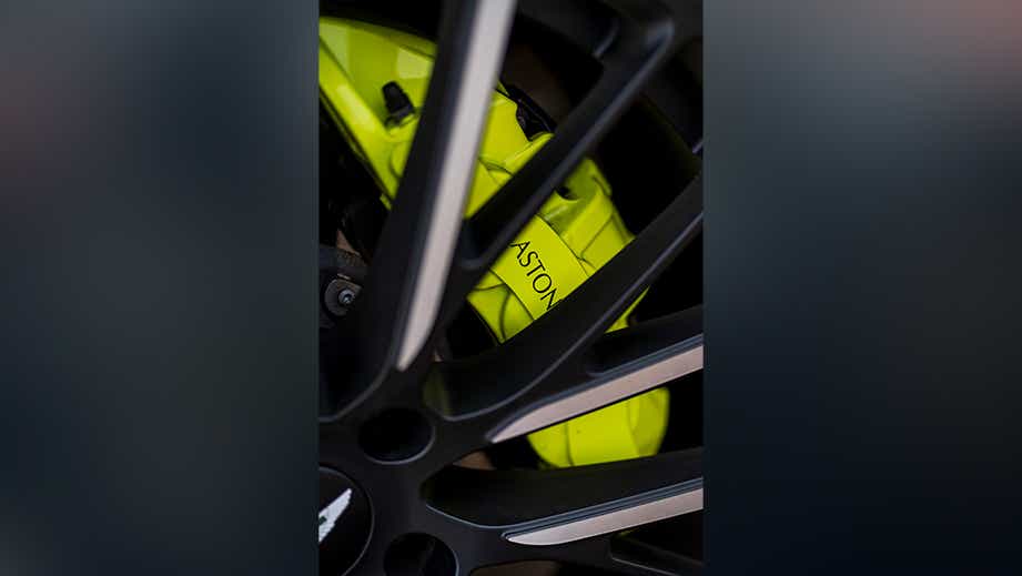 Wheel and brake caliper close-up of a Photon Lime Aston Martin DBX