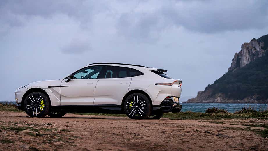 rear three-quarter of a Satin Lunar White Aston Martin DBX