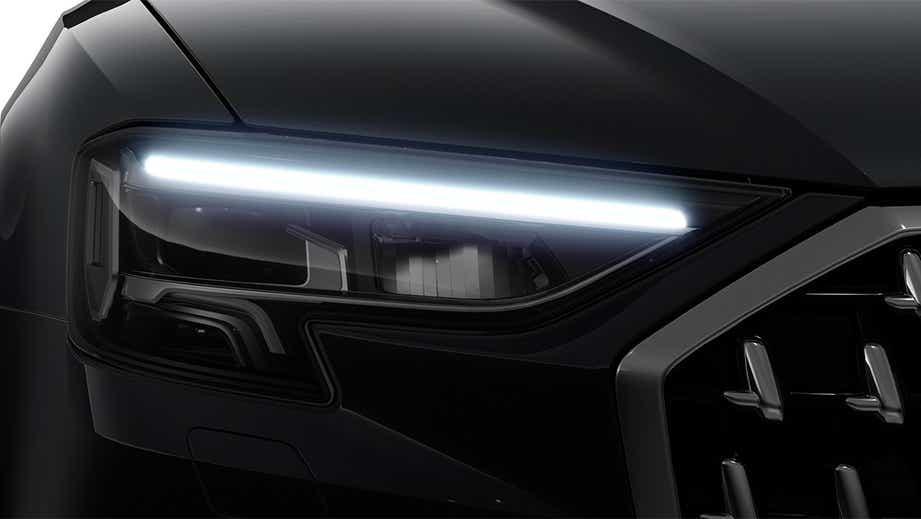 Headlight close-up of a Vesuvius Gray Metallic Audi A8 L