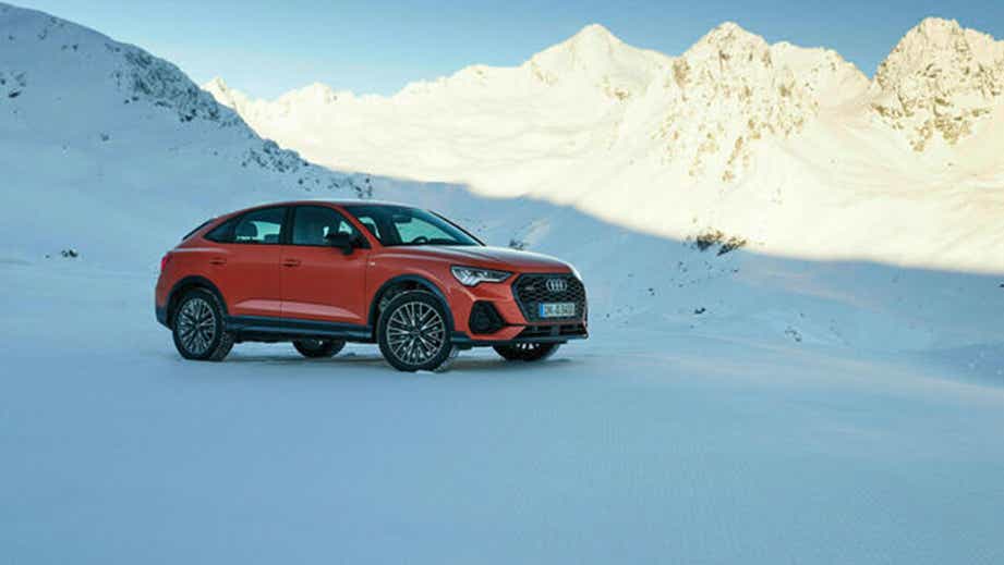 side view of an Audi Q3 Sportback on a snowy mountain road