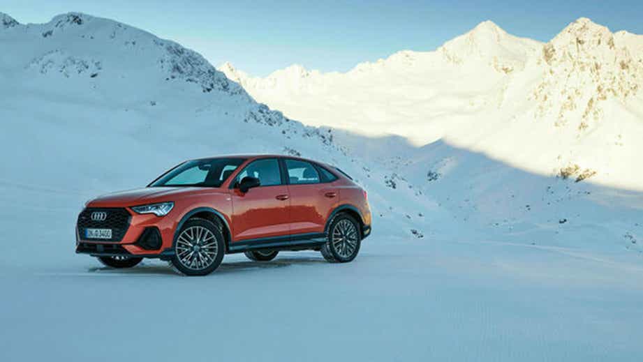 side view of a Audi Q3 Sportback in snowy mountains