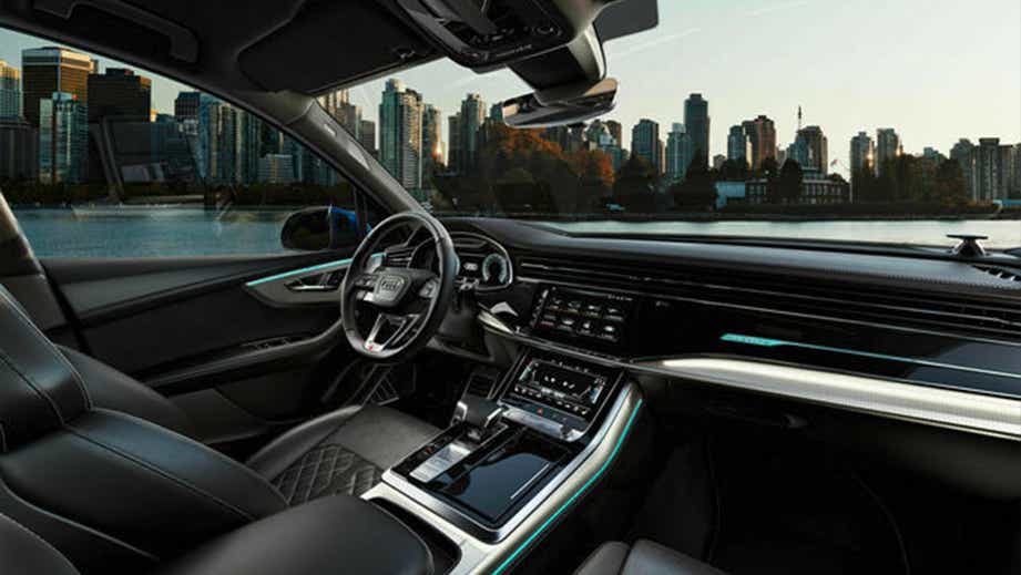 Interior view of an Audi Q7 with city skyline in background