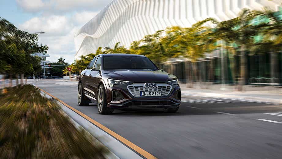 front view of an Audi Q8 Sportback e-tron driving on a city street