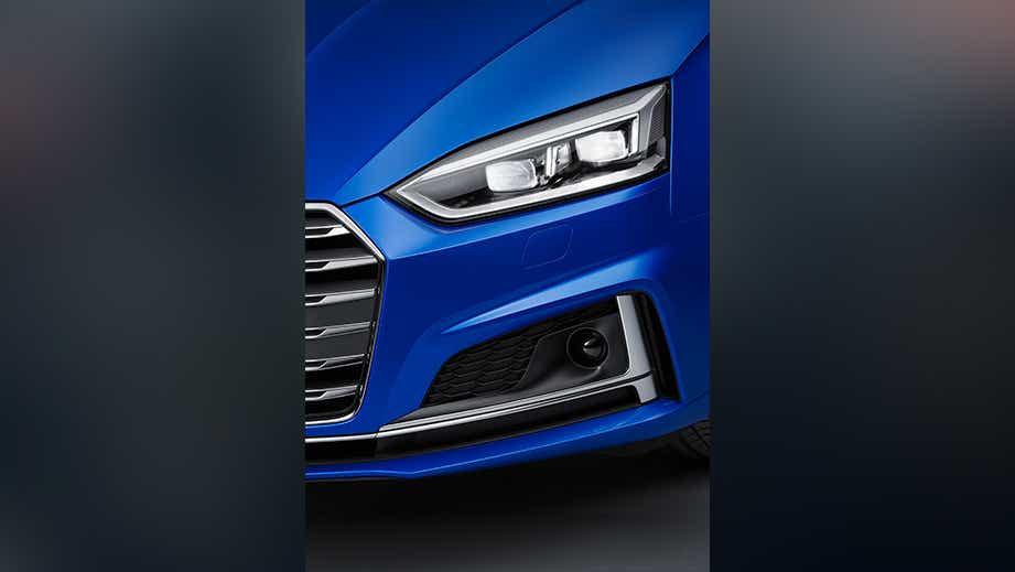 Front headlight and grille of a Tango Red Metallic Audi S5 Sportback