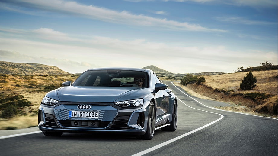 front view of an Audi e-tron GT driving on an open road
