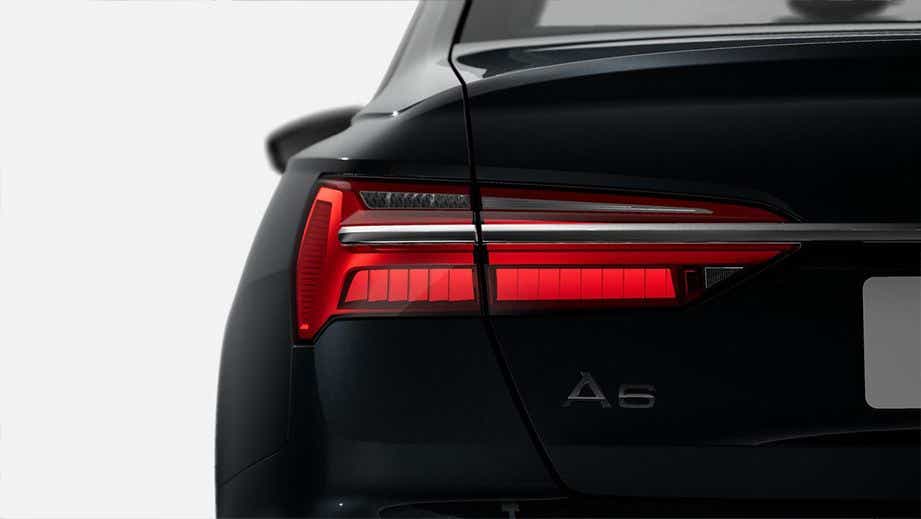 Rear tail light and badge view of a Mythos Black Metallic Audi A6