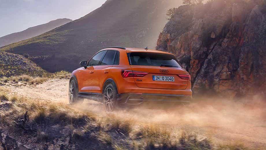 rear three-quarter view of a Pulse Orange Solid Audi Q3
