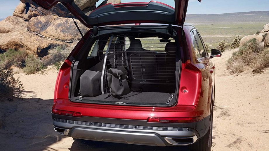 Open boot view of an Audi Q7 2022-2023 on a sandy terrain