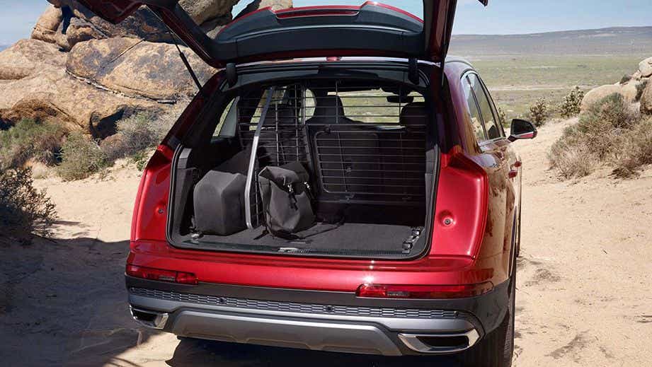 Open boot view of an Audi Q7 2022-2023 on a sandy terrain
