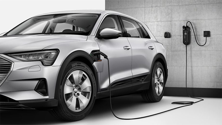 front three-quarter view of an Audi e-tron charging