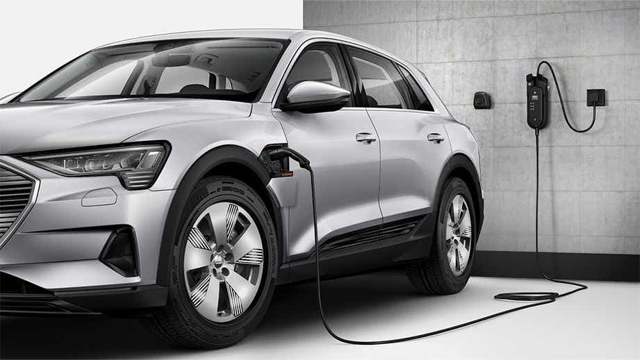 front three-quarter view of an Audi e-tron charging