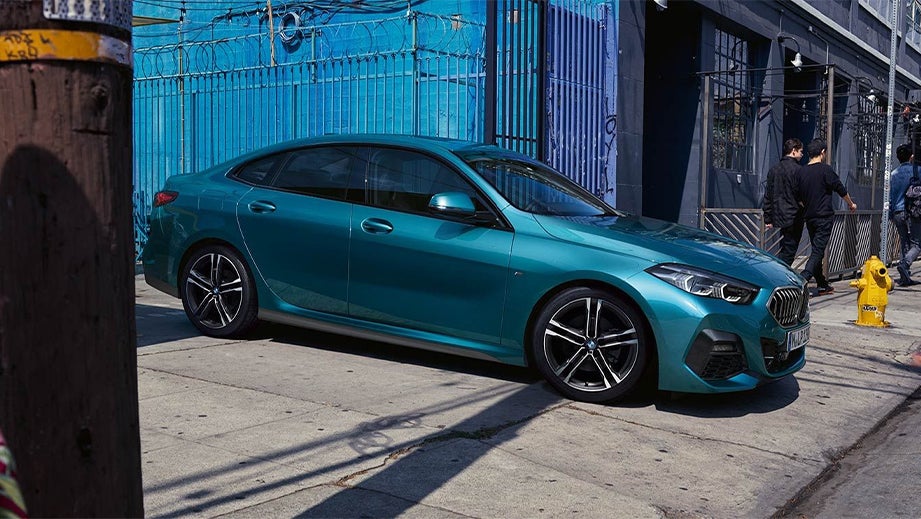 side view of a BMW 2 Series parked on a city street