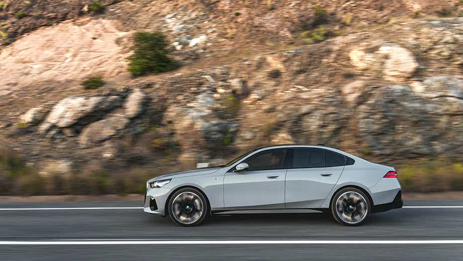 side view of a Mineral White BMW 5 Series