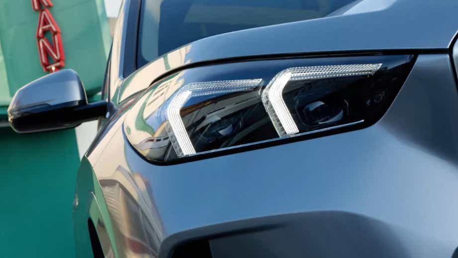 headlight close-up of a Skyscrapper Grey Metallic BMW iX1
