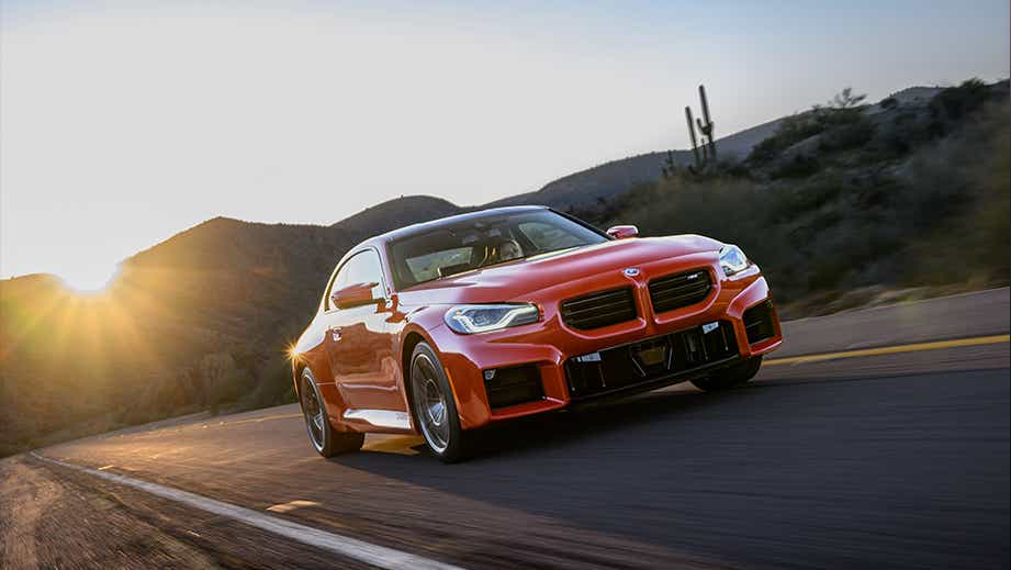 front three-quarter view of a BMW M2 on a desert road