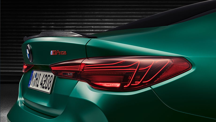 Rear three-quarter view of a BMW M4 Competition in a garage