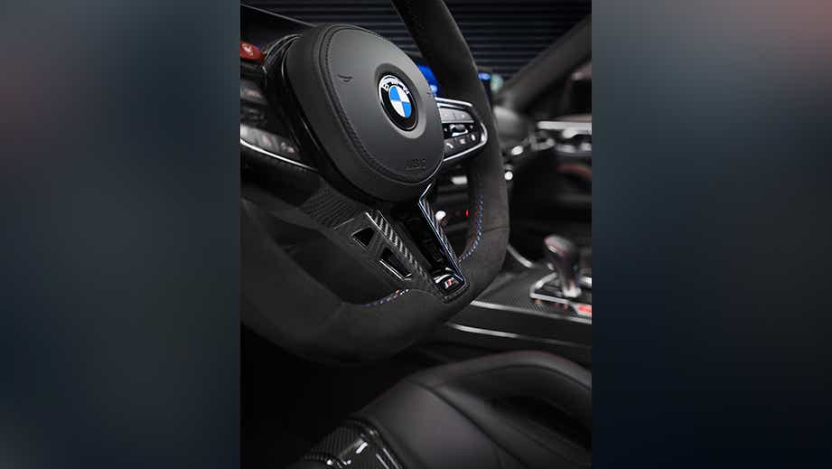 Steering wheel and dashboard of a Black Sapphire BMW M4 Competition