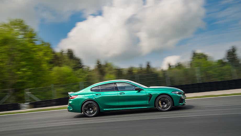side view of a BMW M8 Coupe Competition driving on a track