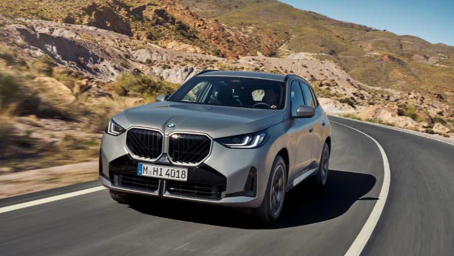 Front view of a BMW X3 on a winding mountain road