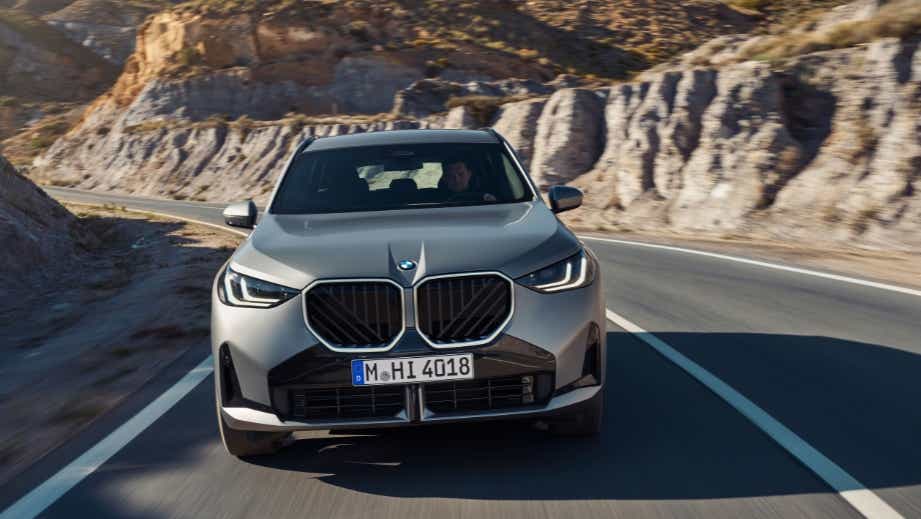 Front view of a BMW X3 on a winding mountain road