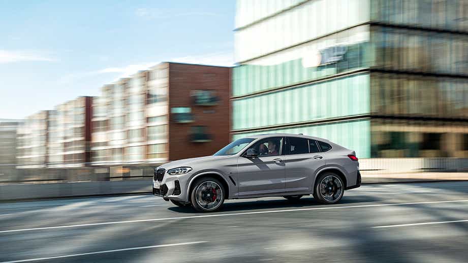 side view of a BMW x4 driving on a city street