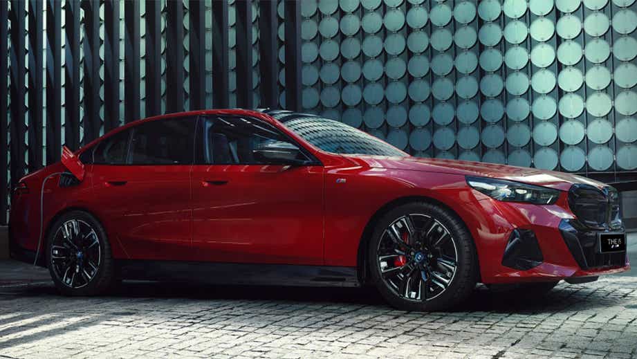 side view of a Fire Red Metallic BMW i5