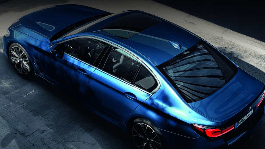 high-angle view of a Phytonic Blue BMW 5 Series 2021-2023